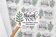 a sticker that says thank you for shopping small this season with a christmas tree on it