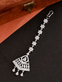 Maang Tikka - White CZ and AD stone silver Indian Tikka / Diamond Maang tikka /Bridal Wear/ Small Tikka /American Diamond Silver Maang Tikka Beautiful and Unique American Diamond (AD) Maang Tikka with floral shape. These would definitely complete your entire look for your special event. This maang tikka has a minimalistic style, are very lightweight, and are perfect for kids as well. Size & Fit Dimensions: 8 cm x 2.8 cm (Length x Width) Care Instructions: Wipe your jewellery with a soft cloth after every use Always store your jewellery in a flat box to avoid accidental scratches Keep sprays and perfumes away from your jewellery Do not soak your jewellery in water Clean your jewellery using a soft brush, dipped in jewellery cleaning solution only Complete The Look Take your ethnic accessori Luxury Silver Tikka For Festive Occasion, Dazzling Silver Bridal Necklace With Stone Setting, Traditional Silver Tikka As Gift, Silver Diamond Bridal Necklace With Stones, Traditional White Gold Bridal Necklace, Dazzling Silver Bridal Necklace For Festive Occasion, Silver American Diamond Jewelry With Stones, Silver Tikka For Diwali Reception, Traditional Silver Jewelry With Sparkling Stones