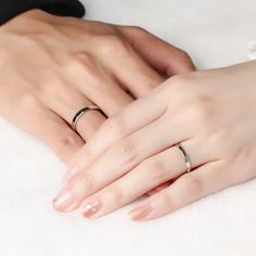 two people with wedding rings on their hands