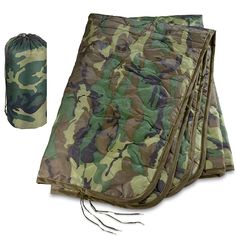 the camouflage sleeping bag is folded up and ready to be used as a camping blanket