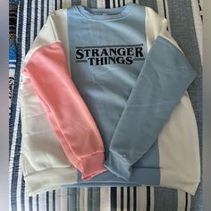 Stranger Things Multicolored Crewneck Sweatshirt! Is Size L But Fits Like A Medium. Never Worn Before! All Clothing Is Washed And Ironed Before Shipment! Please Let Me Know If You Have Any Questions! Spring Crew Neck Sweatshirt With Contrast Color, Pink Color Block Sweatshirt For Spring, Trendy Pink Color Block Sweatshirt, Pink Casual Color Block Sweatshirt, Casual Pink Color Block Sweatshirt, Pink Long Sleeve Top With Contrast Color, Trendy Pastel Crew Neck Top, Pink Casual Tops With Contrast Color, Pink Patchwork Crew Neck Top