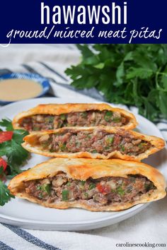 two beef empanas on a white plate with cilantro