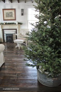 a living room with a christmas tree on the floor