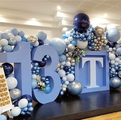 balloons and decorations are arranged around the letters that spell out the word bt8t