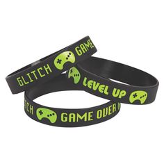 two wristbands with game over written on them, one is black and the other green