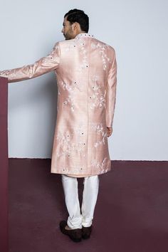 Rose tint silk sherwani with mirror and pearl embroidery. Comes with a heavy embroidered stole, kurta and pant.
Components: 4
Pattern: Embroidered
Type Of Work: Pearl, Mirror
Neckline: Band collar
Sleeve Type: Long
Fabric: Raw Silk
Color: Peach
Other Details: 
Approx. product weight: 1.5 kgs
Occasion: Wedding - Aza Fashions Luxury Long Sleeve Pink Sherwani, Luxury Pink Ceremonial Sherwani, Luxury Pink Sherwani With Dupatta, Luxury Dola Silk Unstitched Wedding Suit, Pearl Mirror, Kurta And Pants, Garden Mirror, Pearl Embroidery, Raw Silk Fabric