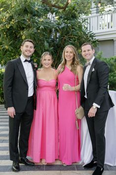 three people in formal wear standing next to each other