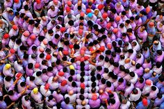 a large group of people standing next to each other in the middle of a crowd