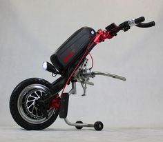 a black and red motorcycle parked on top of a white floor