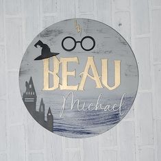 a sign that reads beau michael with a wizard hat and glasses on it's face