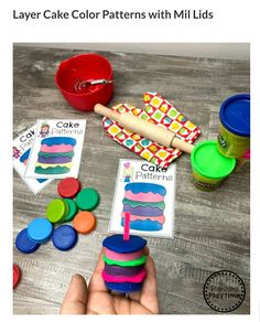 a person is holding a piece of cake in front of some play dough and cupcakes