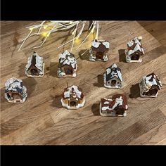 several pieces of chocolate cake sitting on top of a wooden table next to christmas lights