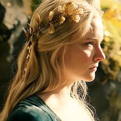 a woman with long blonde hair wearing a flower crown