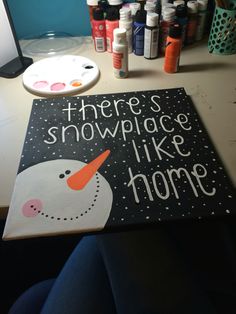 there's snowplace like home painted on a canvas in front of a computer