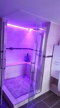 a bathroom with a purple light in the shower