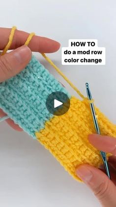 someone is crocheting the bottom part of a yellow and blue knitted object