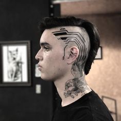 a man with tattoos on his head and neck