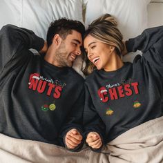 Funny Couples Christmas Chest & Nuts Sweatshirt - Customizable Names Add some festive fun to your holiday season with our Funny Couples Christmas Chest & Nuts Sweatshirt! This hilarious sweatshirt is perfect for couples who want to celebrate the holidays with humor. The design features "Chest" with two jingly Christmas bells at the bottom and "Nuts" with two traditional Christmas balls, all adorned with a Santa hat and reindeer antlers wrapped in colorful Christmas lights. Make it even more special by customizing your names on the sweatshirt! Personalize your names in 15 different DTG printing colors to match your sweatshirt, while the main design stays true to the classic holiday colors. Key Features: - 14 Sweatshirt Colors: Choose from a wide range of festive colors. - Funny Christmas De Family Christmas Onesies, Colorful Christmas Lights, Sweatshirt Colors, Couples Christmas, Pajama Outfit, Cute Christmas Outfits, Matching Family Christmas Pajamas, Couple Pajamas, Reindeer Antlers