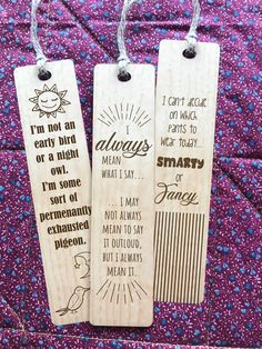 two wooden bookmarks with words on them