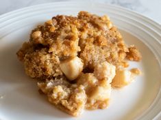 a close up of a plate of food with crumbs and bread on it