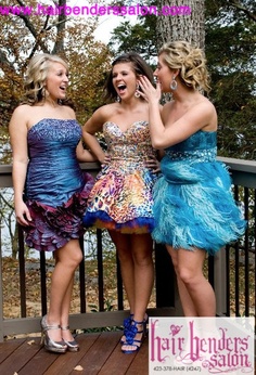 three women in dresses standing on a deck talking to each other with their mouths open