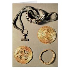 an assortment of gold jewelry including bracelets, rings and pendants on a white background