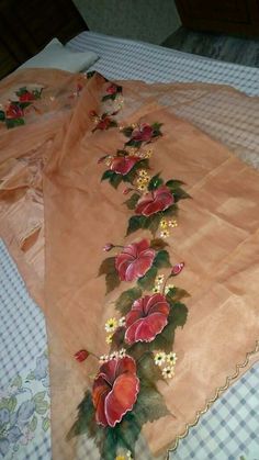 an embroidered table runner with flowers on it