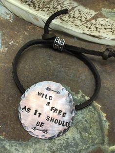 Wild and Free As It Should Be bracelet is a handmade beauty any free spirited boho cowgirl will boldly and proudly wear. This showpiece has a gorgeous medallion featuring arrows and hand stamped lettering. Handmade in Idaho by Weathered Soul exclusively for Bourbon Cowgirl. Limited Edition, high quality jewelry that is as unique and authentic as you! Due to their handcrafted nature, slight variations will occur. The feel and design of the product will remain true to the overall aesthetic. Featur Inspirational Adjustable Hand Stamped Jewelry, Bohemian Stamped Bracelets As Gift, Nickel-free Bohemian Jewelry For Friendship, Bohemian Hand Stamped Bracelets For Gift, Bohemian Hand Stamped Bracelets For Gifts, Adjustable Stamped Bracelets For Festivals, Bohemian Hand Stamped Bracelets As Gift, Bohemian Hand-stamped Bracelets For Gifts, Adjustable Stamped Jewelry For Festivals