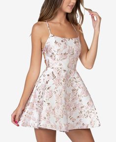 Go for glam in this strappy lace-up dress from B Darlin, a sleeveless pick designed with shimmery metallic detail and embroidery. Elegant Floral Print Mini Dress For Homecoming, Beige Prom Dress For Spring, Spring Beige Prom Dress, White Mini Dress For Spring Homecoming, Cream Dress For Spring Night Out, Elegant Cream Floral Print Mini Dress, Elegant Spring Mini Dress For Homecoming, Feminine Spring Homecoming Dress, Small Floral Pattern