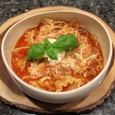 a white bowl filled with pasta and sauce