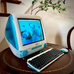 a desktop computer sitting on top of a wooden table next to a keyboard and mouse