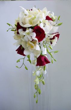 a bouquet of white and red flowers in a vase