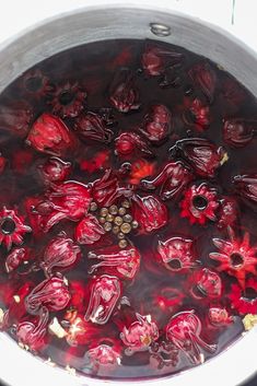 a pot filled with red liquid sitting on top of a stove