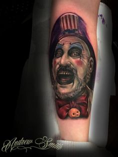 a man with a clown mask on his arm