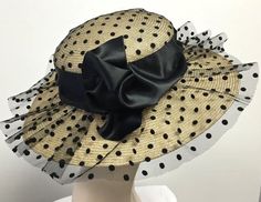 Kentucky Derby hat black and Natural straw women hat hand blocked by traditional millinery techniques. Trimmed with black tulle embossed with small black polka dots. Beautifully trimmed with 4 inch double faced satin - center bow very pleasingly hand shaped. Inspired by the spring designs of the Chanel spring runway. Very romantic look! Inside band has an enclosed ribbon to adjust for your day to day comfort. This hat can be custom made in many colors. Please convo me and I will set up a spec... High Tea Hats, Horse Race Hats, Easter Hats, Womens Hat, Trendy Hat, Kentucky Derby Hat