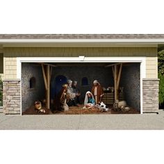 a garage with an image of the birth of jesus and other animals in front of it