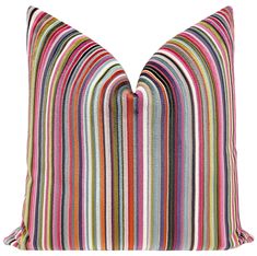 a multicolored striped pillow on a white background