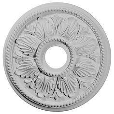 a white ceiling medallion with an intricate design