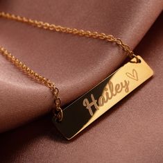 "Celebrate in style with our 16k Gold Plated Custom Name Necklace.  The perfect personalized gift for birthdays and anniversaries.  Show your love with a unique name pendant that exudes elegance.  Make their special occasion unforgettable with this exquisite keepsake. # HOW TO ORDER 1. Choose the Main + Side Heart Color 2. Click 'Add to Cart'  3. Write Customization on 'NOTE TO SELLER'  Fill the option blank with prefer message (2 max letters include symbol and spaces) # SPECIFICATION Material : Bar Bracelet Personalized, Pretty Jewelry Necklaces, Vibe Check, Unique Name, Fancy Jewellery Designs, Name Pendant, Jewelry Aesthetic, Gold Name Necklace, India Jewelry