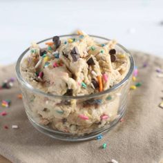 a bowl filled with ice cream and sprinkles on top of a napkin