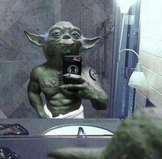 an image of yoda taking a selfie in the mirror with his cell phone