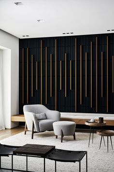 a living room filled with furniture and a wooden slatted wall behind the couch