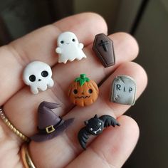 there are many small halloween decorations in the hand