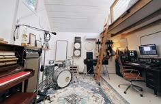 a room filled with musical equipment and lots of clutter on top of carpeted flooring