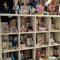 a book shelf filled with lots of anime figurines on top of white shelves