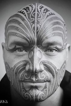 a man with tattoos on his face