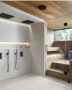 an open bathroom with wooden steps leading up to the bathtub and shower area,