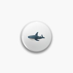 an image of a shark in the sky on a button or magnet that looks like it is floating