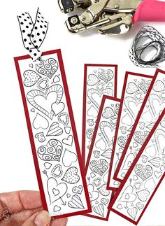 someone is cutting out valentine's day coloring pages with scissors and paper cutters