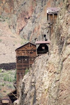 an old wooden structure on top of a mountain